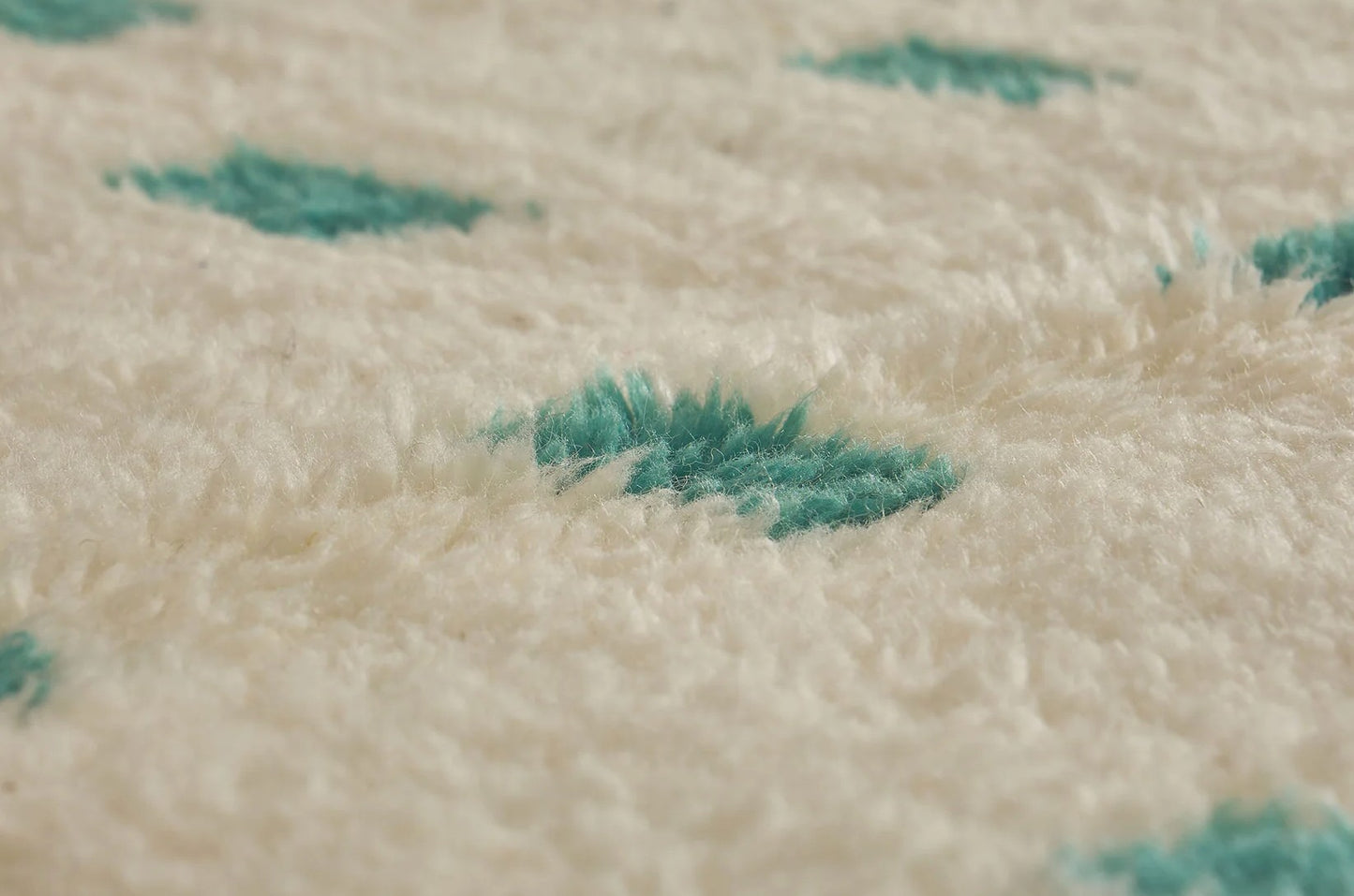 A contemporary Moroccan rug with turquoise geometric patterns on a cream wool base, handwoven for a modern minimalist style. Ideal for living rooms, bedrooms, or offices, this rug is available in customizable sizes.