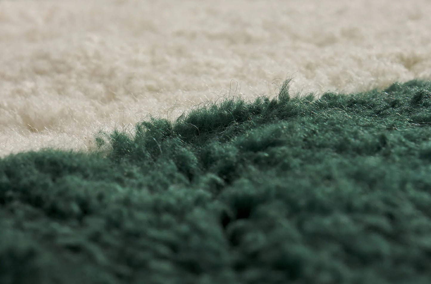 A modern Moroccan rug with bold green geometric stripes on a cream wool base, blending minimalist design and craftsmanship. Handcrafted and available in custom sizes for contemporary interiors.