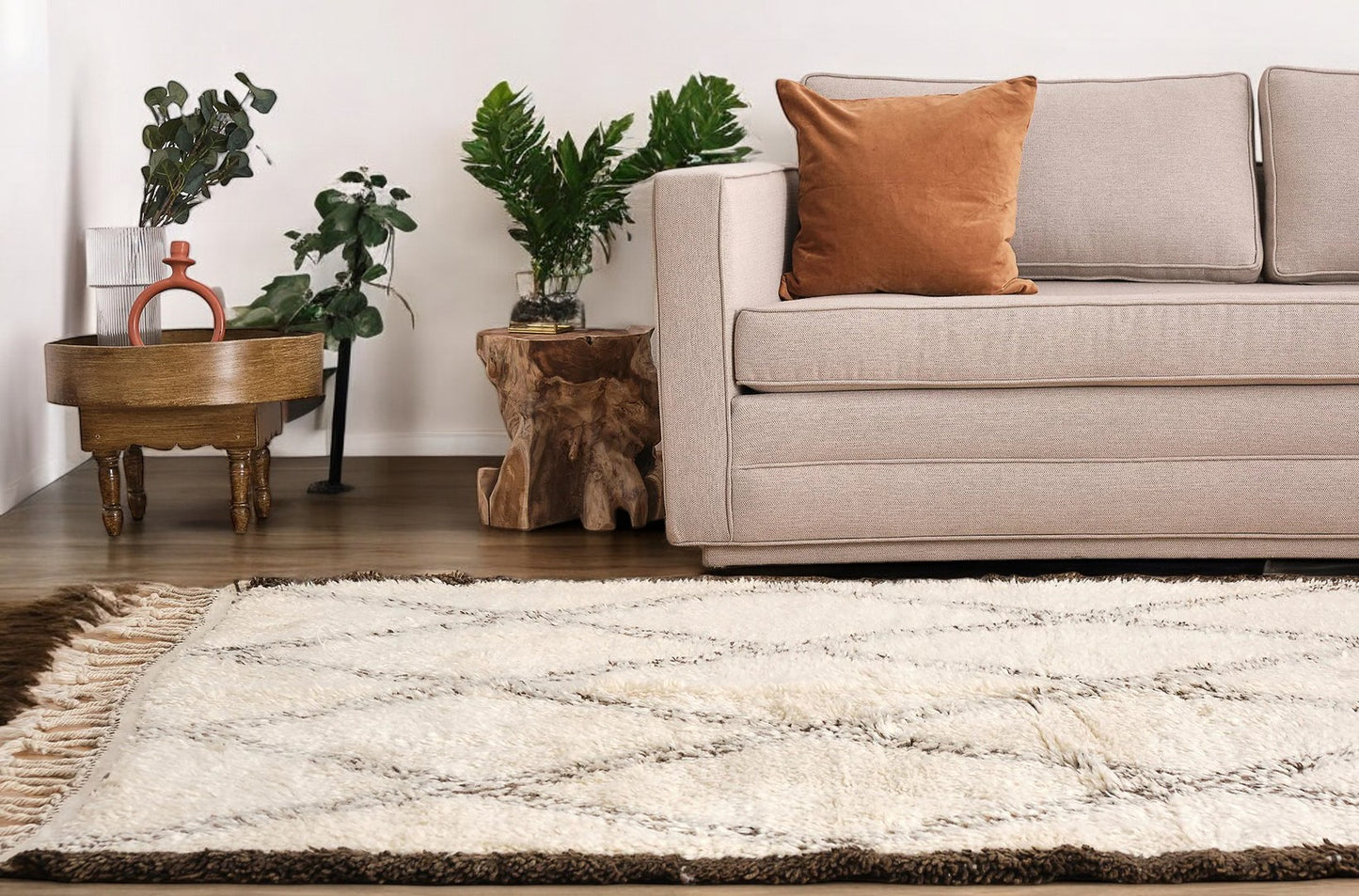 A traditional Moroccan shag rug in cream with a bold brown diamond pattern and tasseled edges, made from natural wool. This rug adds warmth and Moroccan charm to any space and is available in custom sizes.