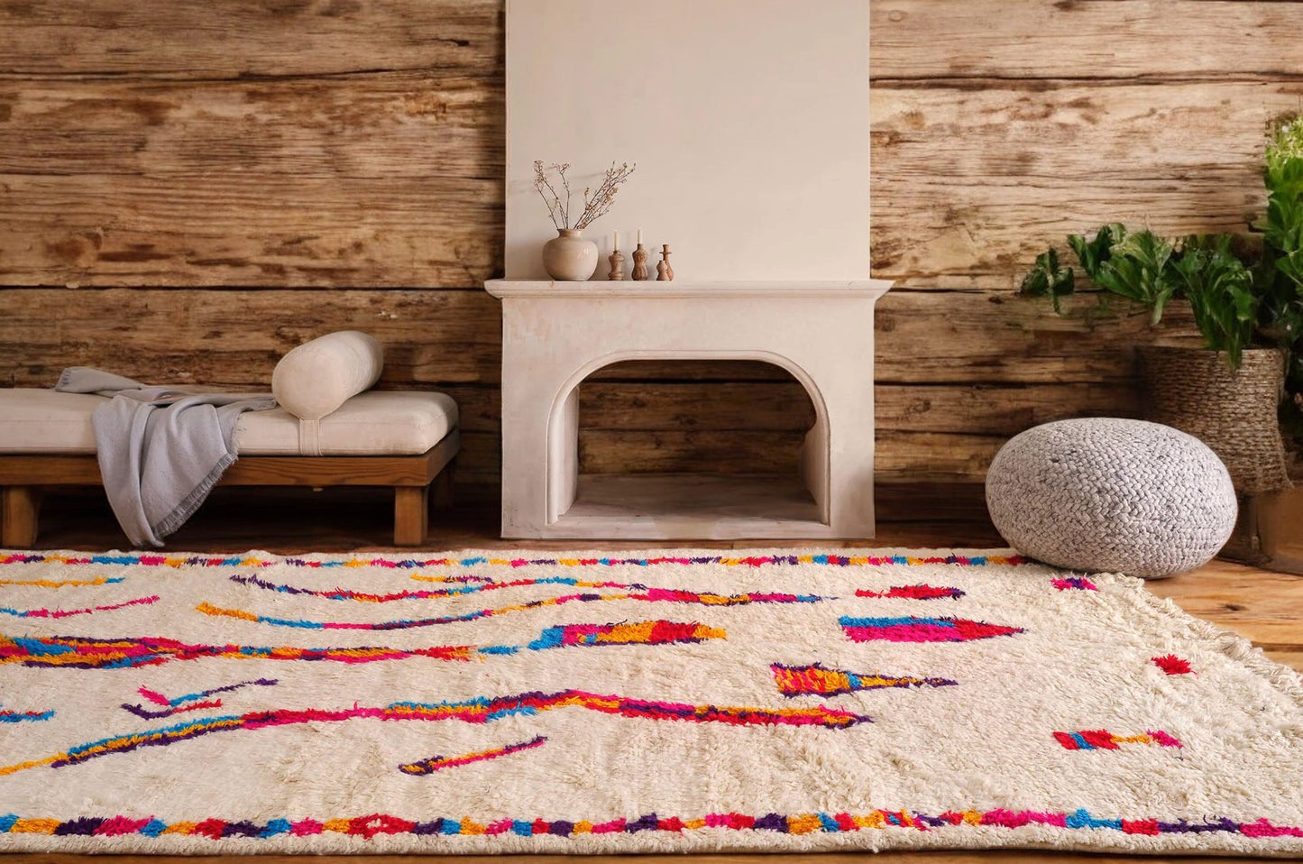 A vibrant Moroccan Boucherouite rug with a bold, colorful abstract pattern on a cream background. Made from natural wool, this rug adds energy and character to bohemian and eclectic interiors and is available in custom sizes.