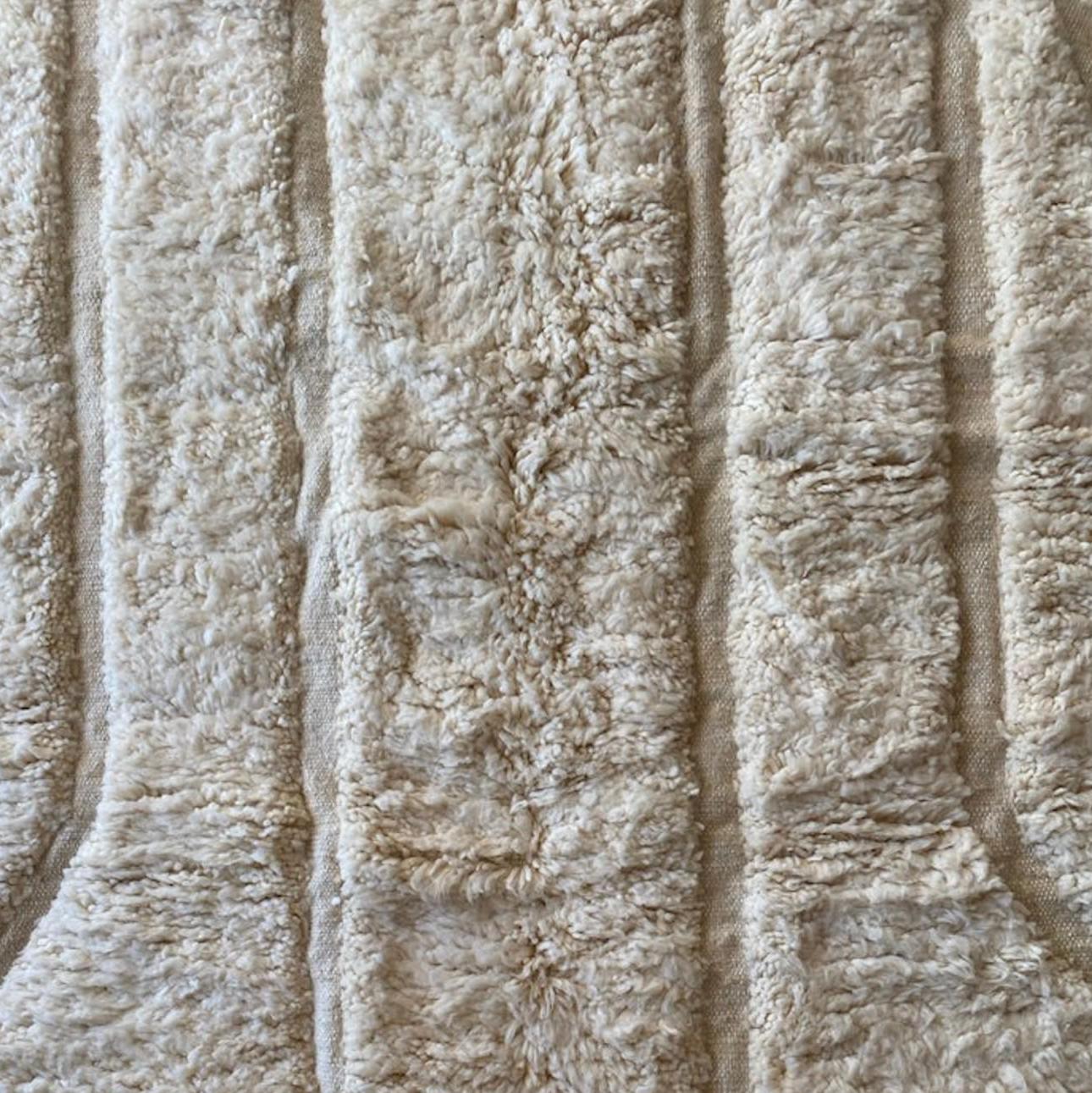 Authentic handmade Moroccan Beni Ourain wool rug in plush cream. Soft, luxurious, and perfect for minimalist, boho, and modern interiors. This high-pile Berber carpet adds warmth and elegance to bedrooms, living rooms, and cozy home spaces. Ethically handwoven.