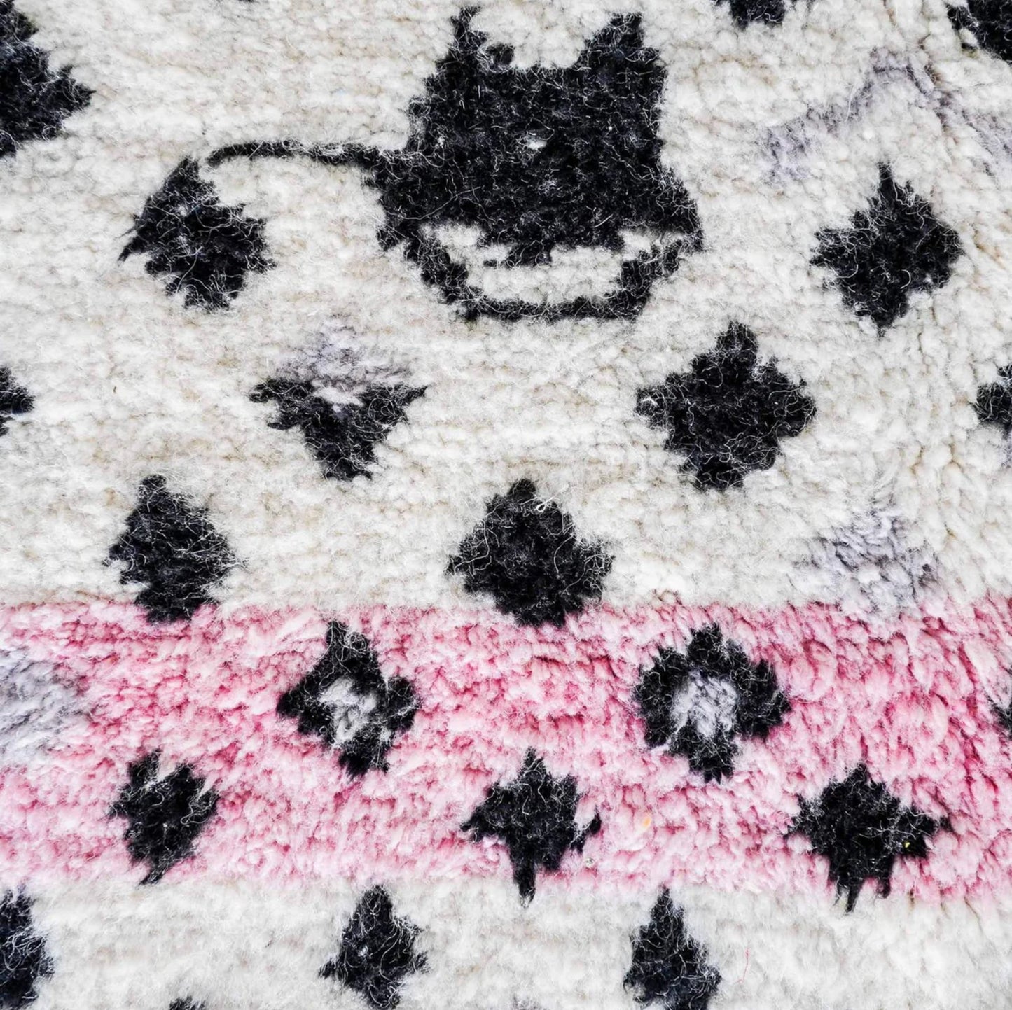 Handmade Moroccan wool rug featuring a bold dotted design in black and pink on a neutral cream base with fringed edges, perfect for bohemian, eclectic, or modern interiors