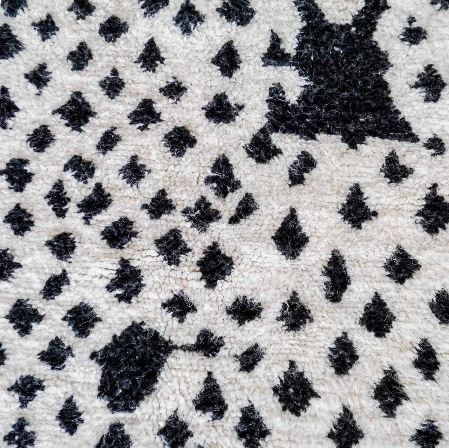 Handmade Moroccan wool rug featuring a bold dotted design in black and pink on a neutral cream base with fringed edges, perfect for bohemian, eclectic, or modern interiors