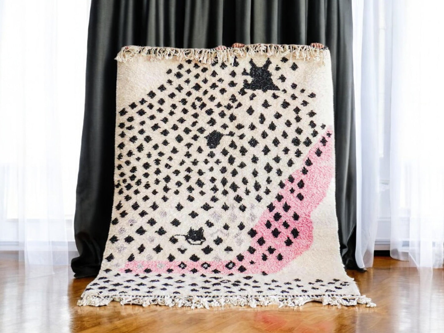 Handmade Moroccan wool rug featuring a bold dotted design in black and pink on a neutral cream base with fringed edges, perfect for bohemian, eclectic, or modern interiors