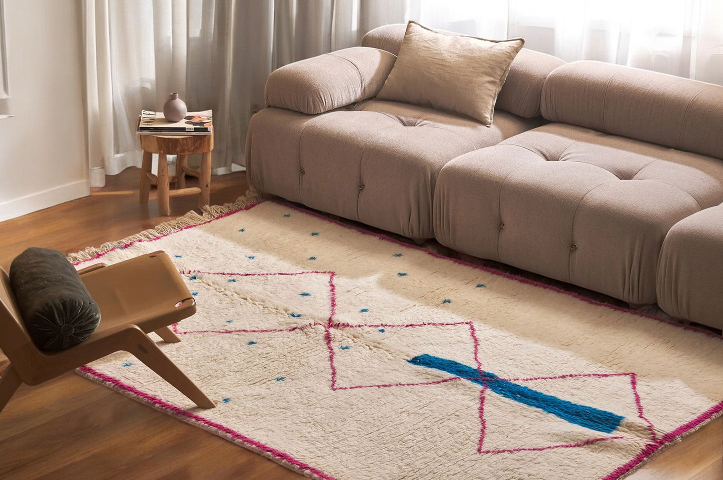 Ivory Moroccan rug with pink diamond pattern and blue accents, featuring a bold blue bar across the design. This handmade rug adds a colorful boho touch to living rooms, bedrooms, or office spaces.