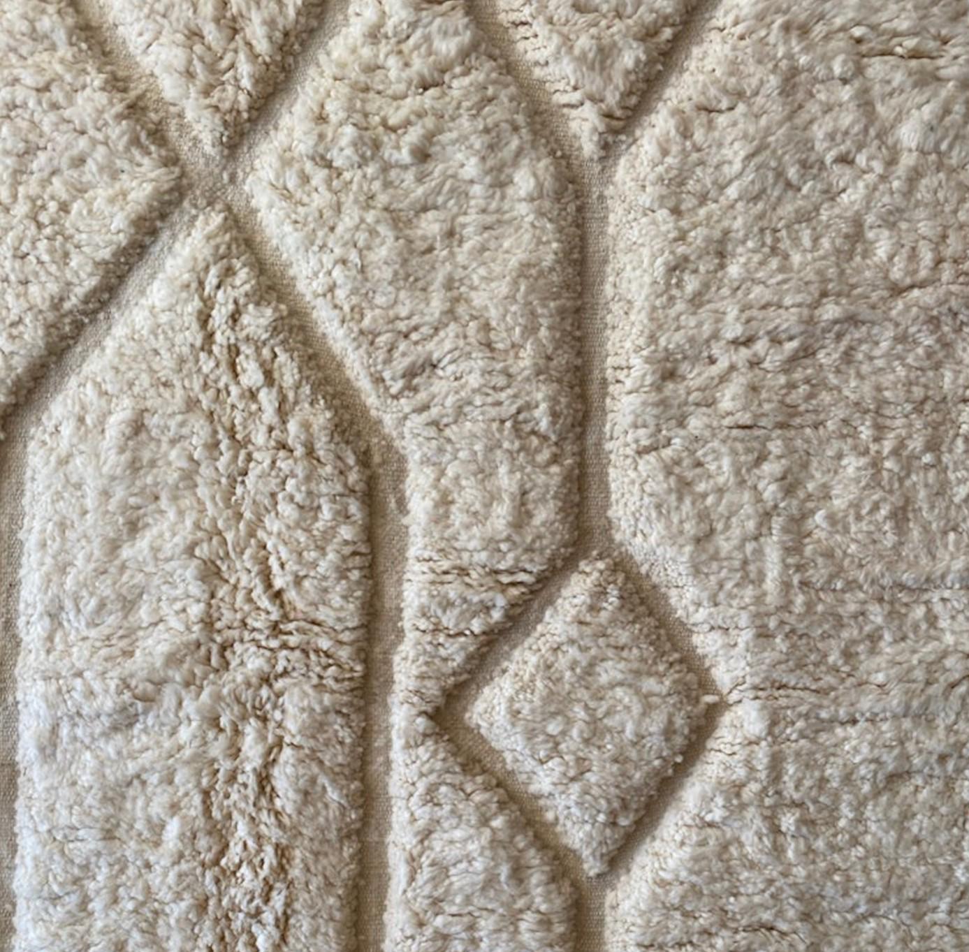 Authentic handmade Moroccan Beni Ourain wool rug in plush cream. Soft, luxurious, and perfect for minimalist, boho, and modern interiors. This high-pile Berber carpet adds warmth and elegance to bedrooms, living rooms, and cozy home spaces. Ethically handwoven.