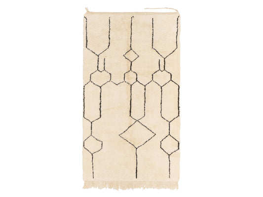 A contemporary Moroccan shag rug in cream featuring a black honeycomb geometric pattern, crafted from natural wool. This unique design adds modern style to any space, available in custom sizes to fit various decor needs.
