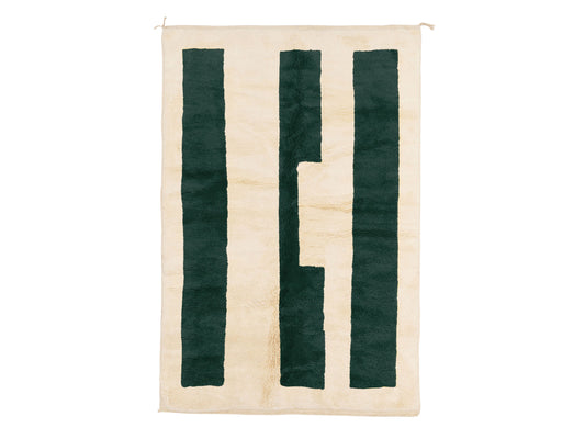 A modern Moroccan rug with bold green geometric stripes on a cream wool base, blending minimalist design and craftsmanship. Handcrafted and available in custom sizes for contemporary interiors.
