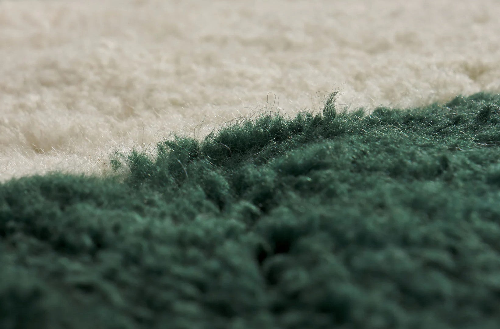A modern Moroccan rug with bold green geometric stripes on a cream wool base, blending minimalist design and craftsmanship. Handcrafted and available in custom sizes for contemporary interiors.

