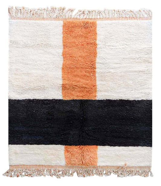 Handmade wool rug with bold horizontal black and vertical terracotta orange stripes on a soft white background, accented with intricate fringe along the edges, ideal for minimalist and modern decor styles."