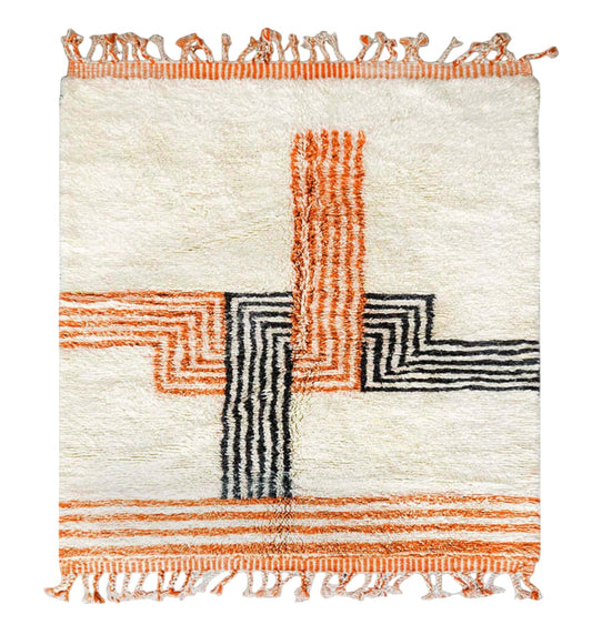 Artisanal handmade wool rug with vibrant orange and black geometric cross patterns on a soft white base, accented by intricate fringed edges, ideal for modern and eclectic decor.