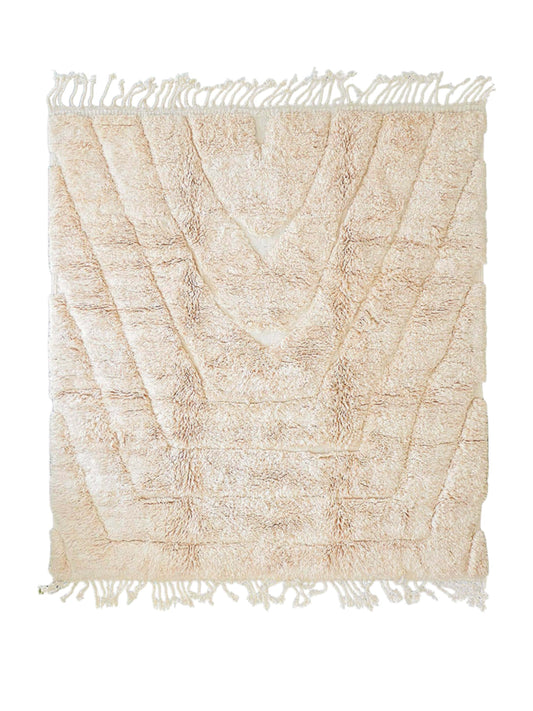 Artisanal handmade wool rug in soft beige featuring subtle textured chevron patterns and fringed edges, perfect for minimalist, modern, or neutral-toned decor styles.