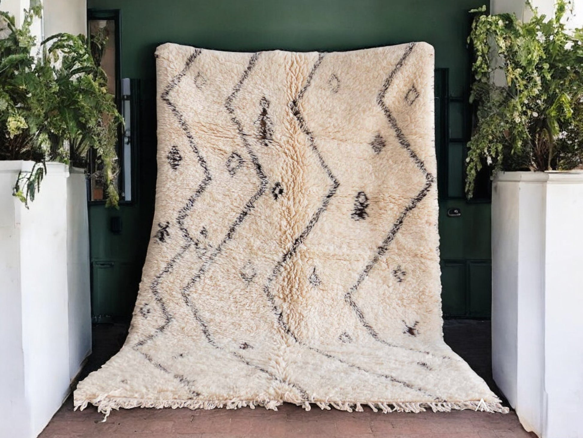 Artisanal handmade wool rug in soft white, featuring minimalist black zigzag and diamond-shaped patterns, designed for a modern, bohemian, or Scandinavian-inspired decor style.