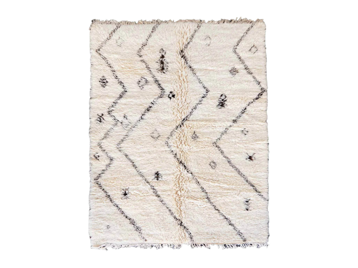 Artisanal handmade wool rug in soft white, featuring minimalist black zigzag and diamond-shaped patterns, designed for a modern, bohemian, or Scandinavian-inspired decor style.