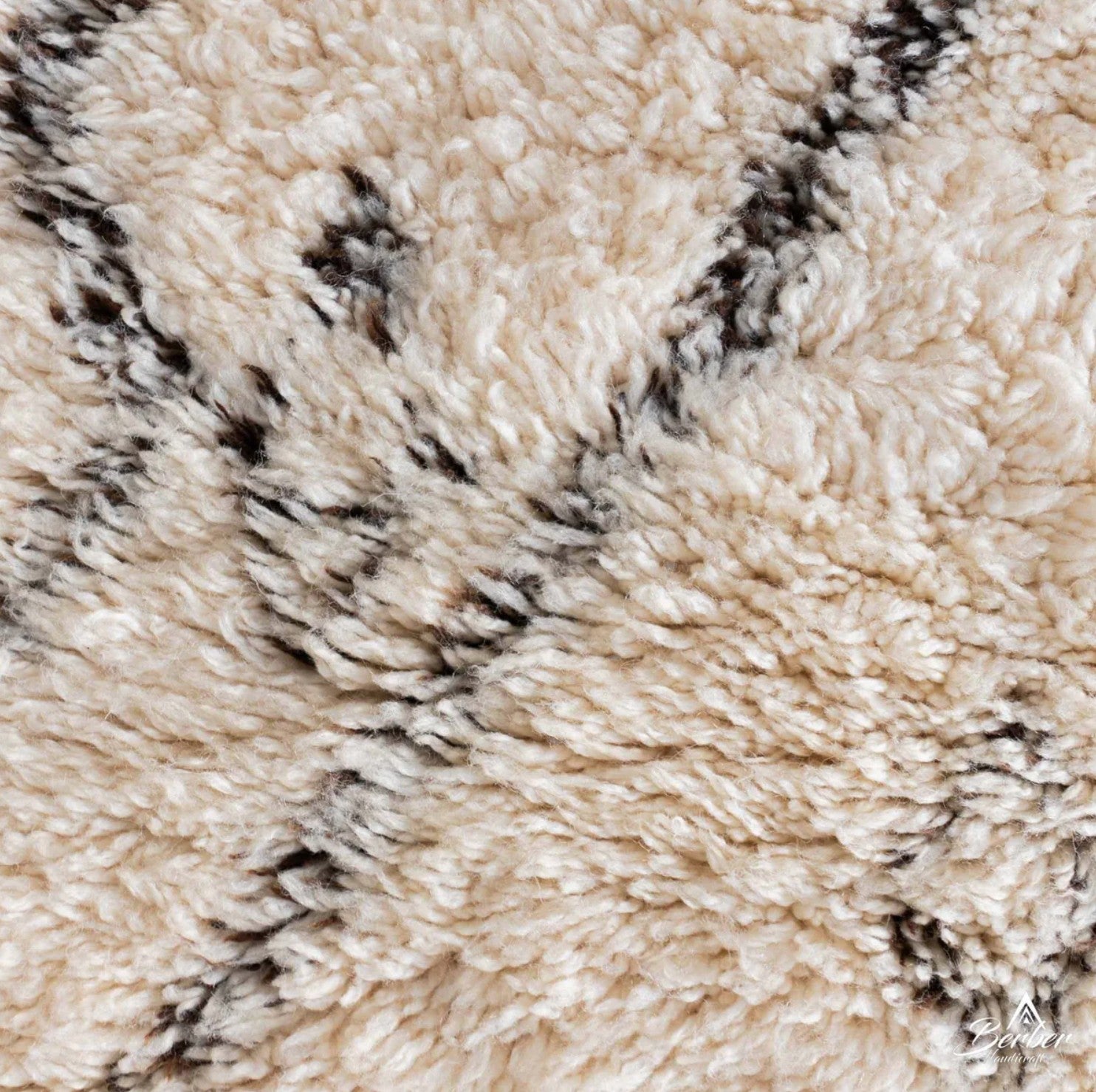 Artisanal handmade wool rug in soft white, featuring minimalist black zigzag and diamond-shaped patterns, designed for a modern, bohemian, or Scandinavian-inspired decor style.