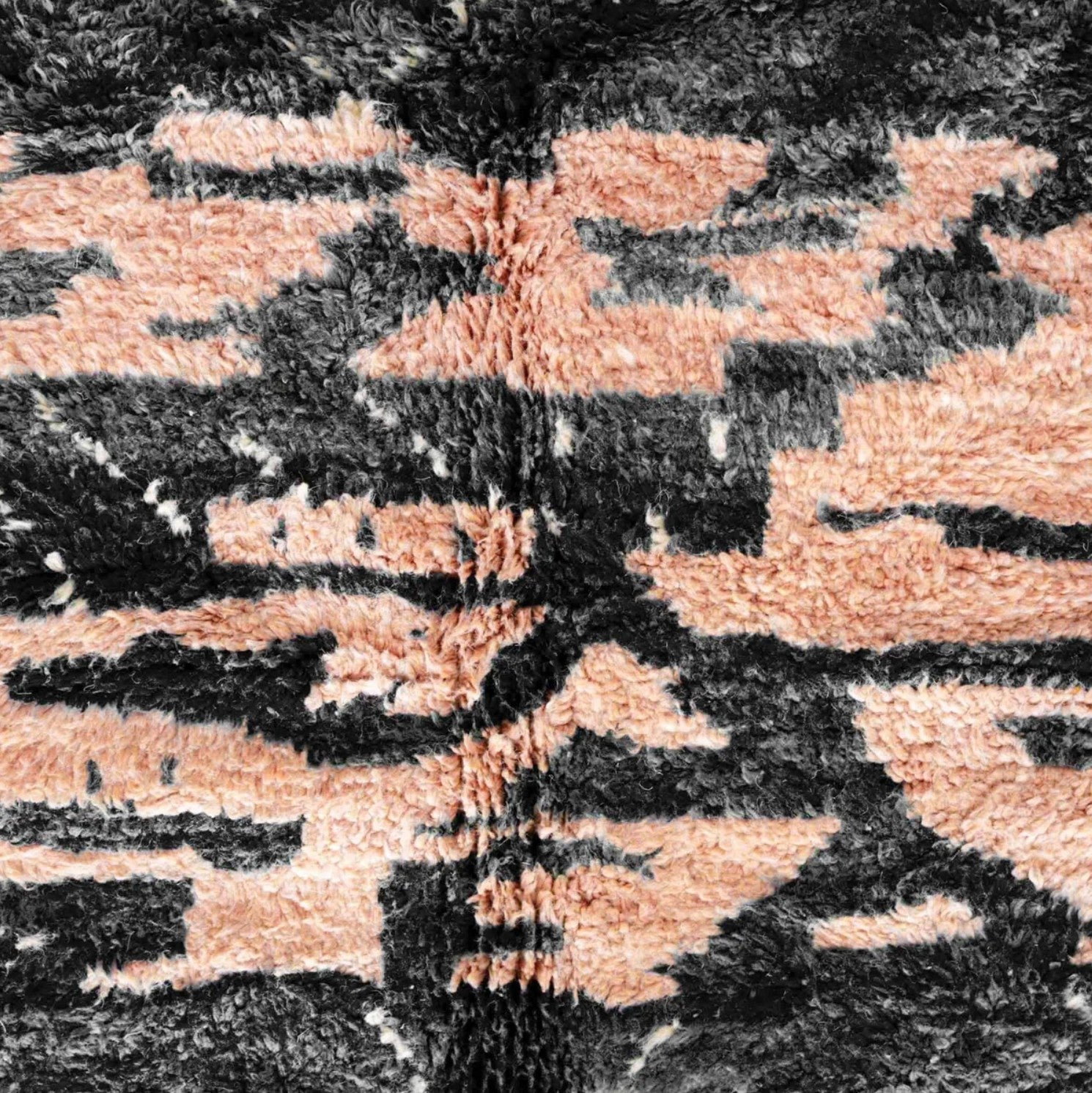Handmade Moroccan wool rug featuring a bold black and peach abstract pattern with fringed edges, ideal for modern, boho, or eclectic interiors
