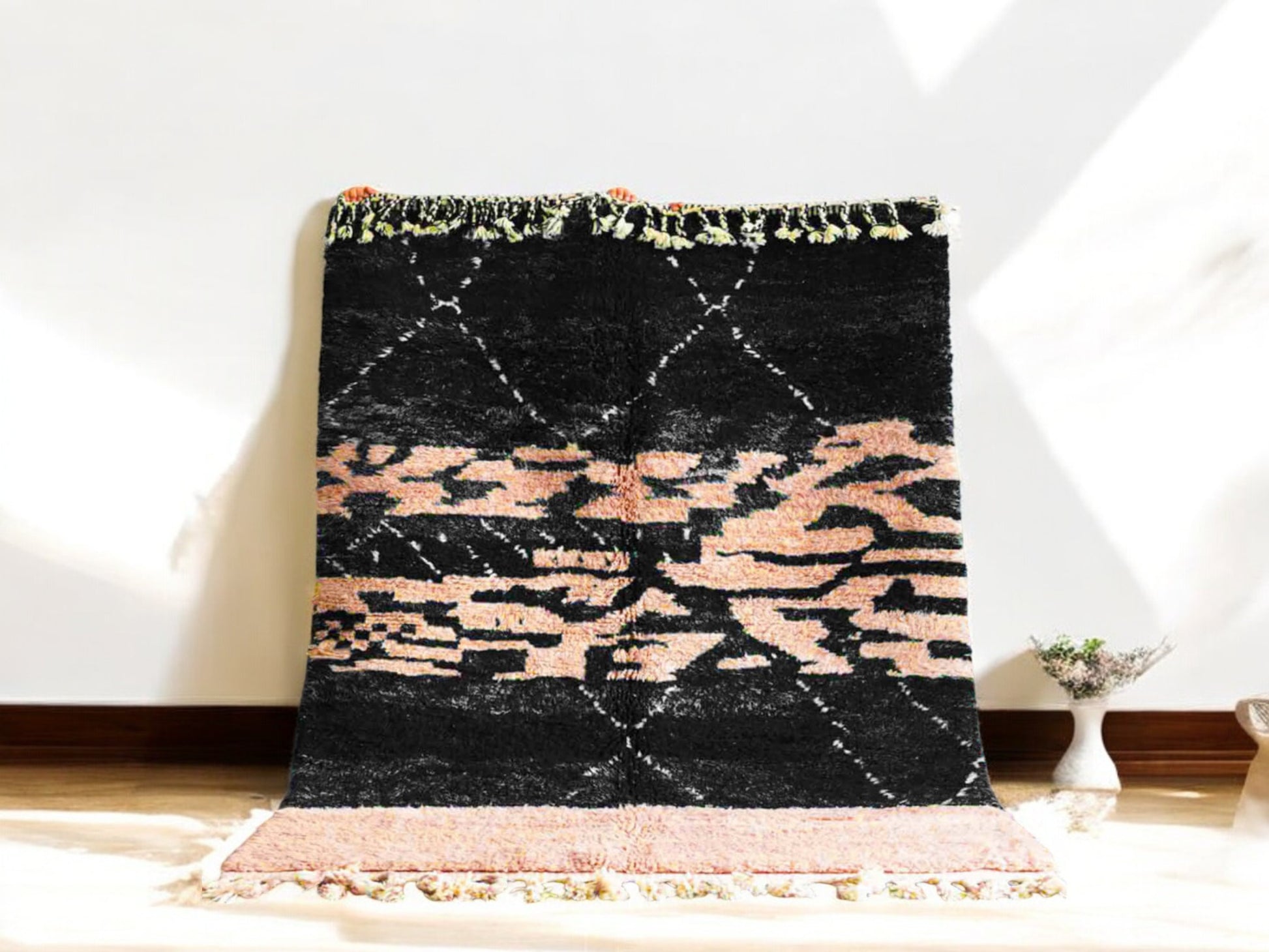 Handmade Moroccan wool rug featuring a bold black and peach abstract pattern with fringed edges, ideal for modern, boho, or eclectic interiors
