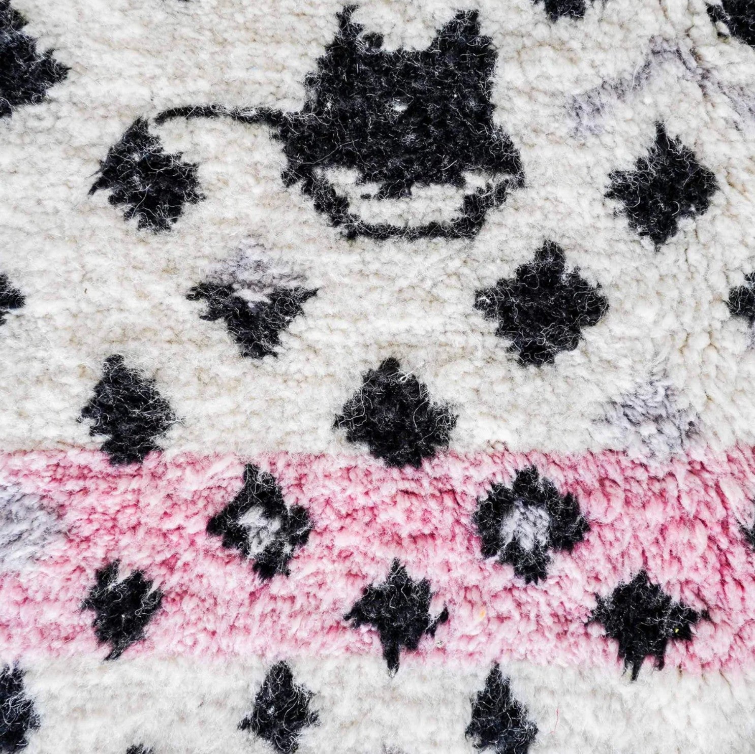 Handmade Moroccan wool rug featuring a bold dotted design in black and pink on a neutral cream base with fringed edges, perfect for bohemian, eclectic, or modern interiors

