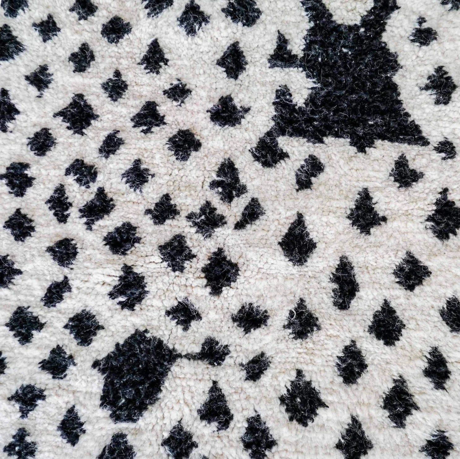 Handmade Moroccan wool rug featuring a bold dotted design in black and pink on a neutral cream base with fringed edges, perfect for bohemian, eclectic, or modern interiors
