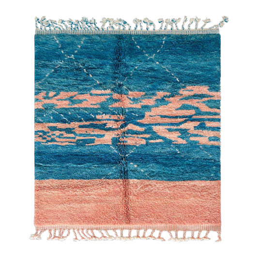 Handmade Moroccan wool rug featuring an ocean-inspired abstract pattern with vibrant blue and pink tones, accented by fringed edges, creating a bold and serene piece for modern or coastal interiors
