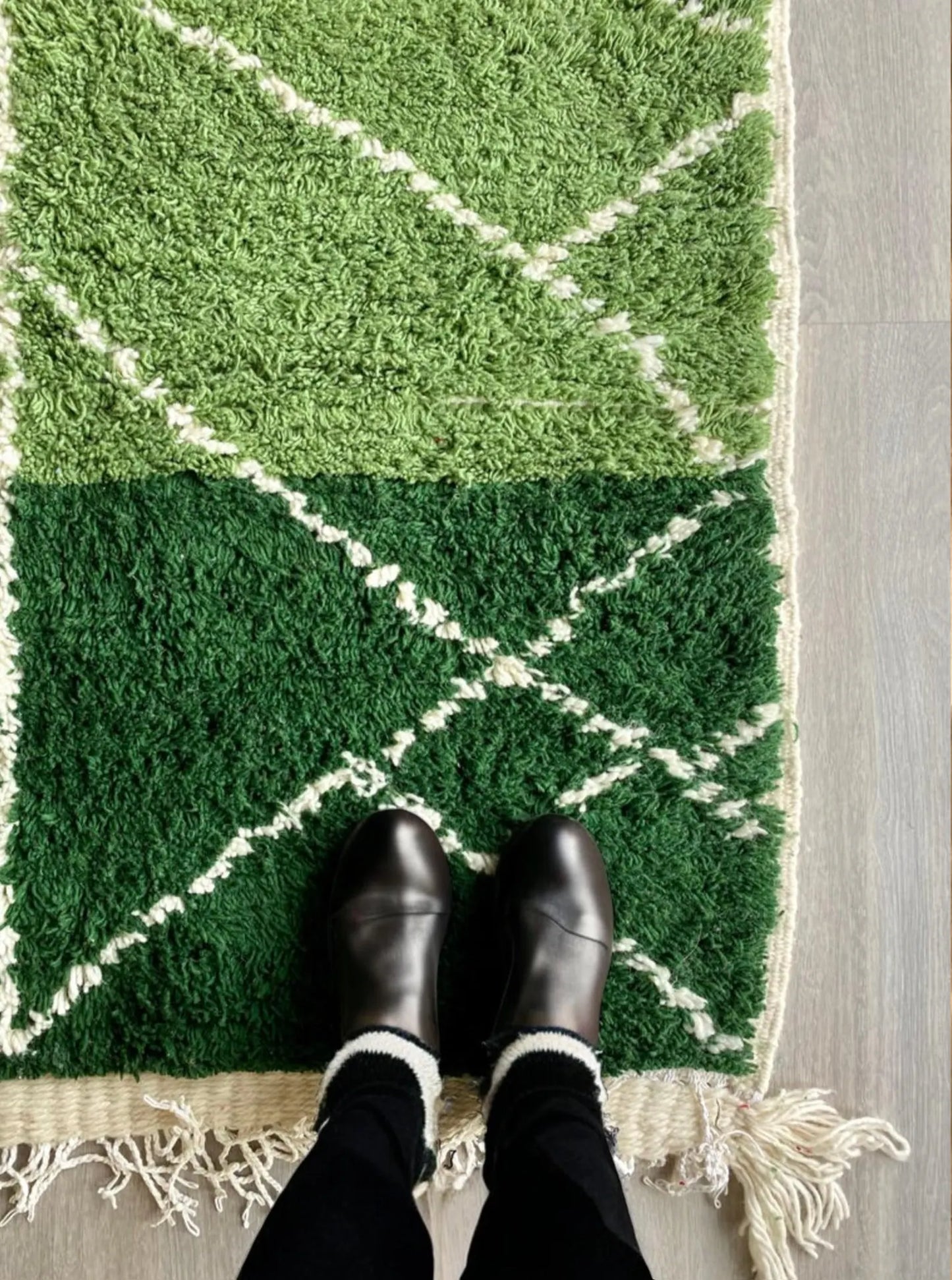 Handmade Moroccan rug in rich green shades with white diamond geometric lines. This Berber wool carpet is woven by skilled artisans using traditional Moroccan techniques, making each rug unique. Its fresh green tones bring life, balance, and a calming natural touch to interiors. Perfect for living rooms, bedrooms, and creative spaces, this eco-friendly wool rug blends tribal heritage with modern bohemian style for timeless Moroccan elegance.