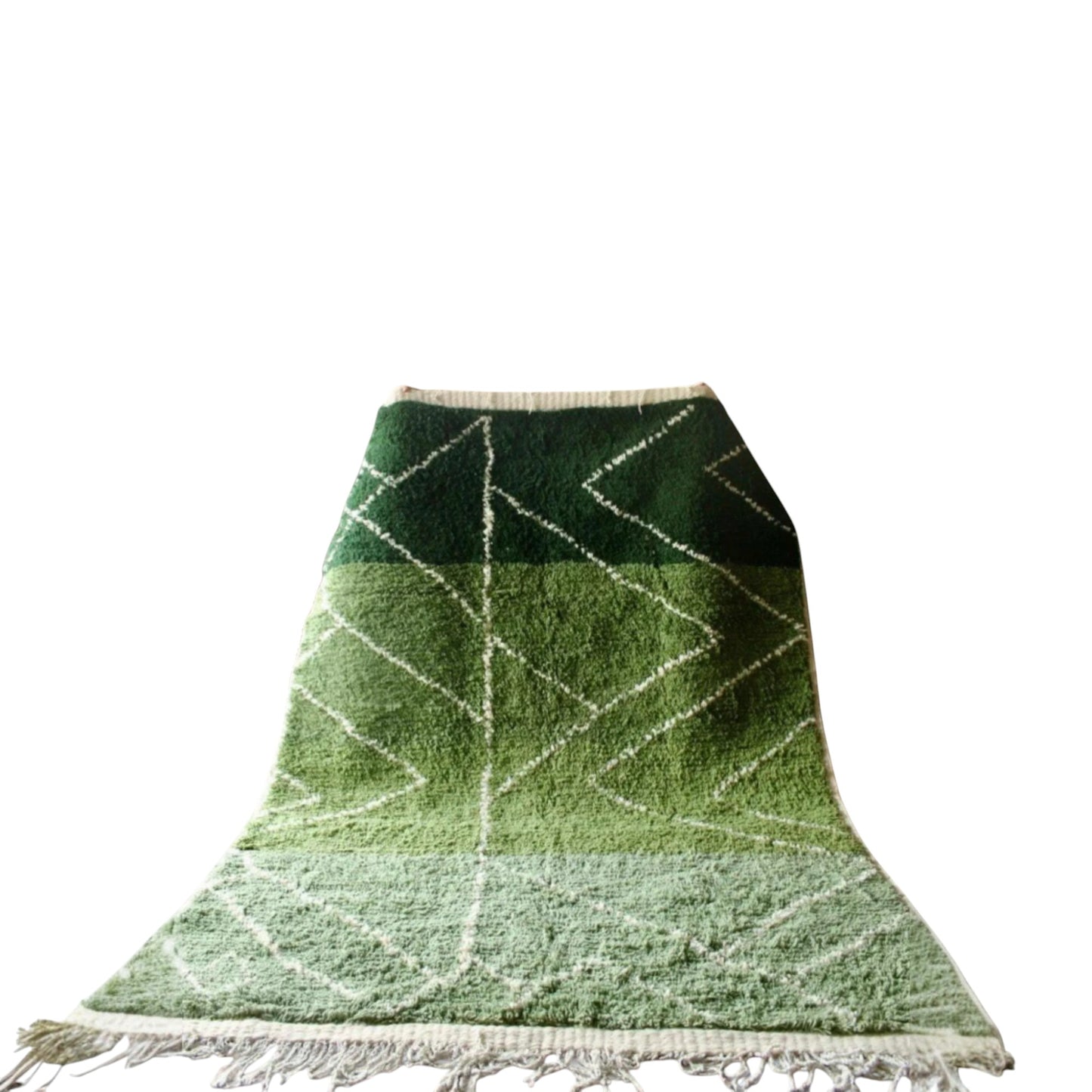 Green woven rug with geometric pattern on a white background